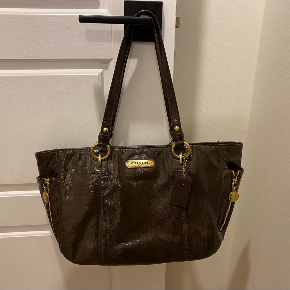 Coach handbag F1260-F20431 brown leather with pink satiny interior lining.